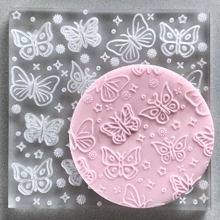 Cookie with Butterfly Magic pattern created using an acrylic fondant debosser