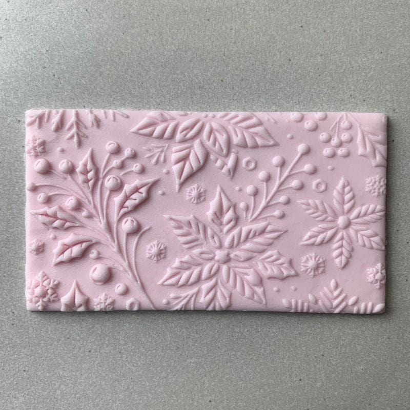 Rectangular fondant cookie with detailed floral embossing using a Christmas cookie stamp