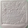 Square fondant cookie with Merry Christmas lettering and festive details using an acrylic cookie stamp