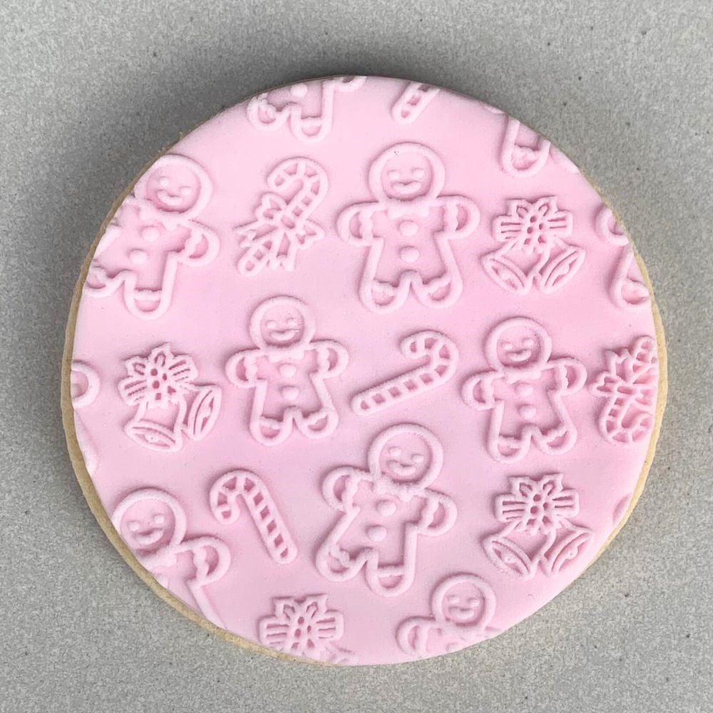 Cookie with Gingerbread Man Christmas pattern created using an acrylic fondant debosser