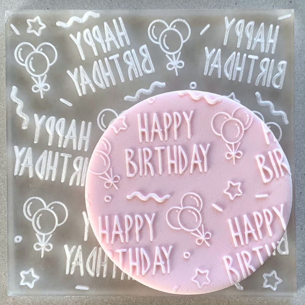 Cookie with Happy Birthday Celebrations pattern created using an acrylic fondant debosser