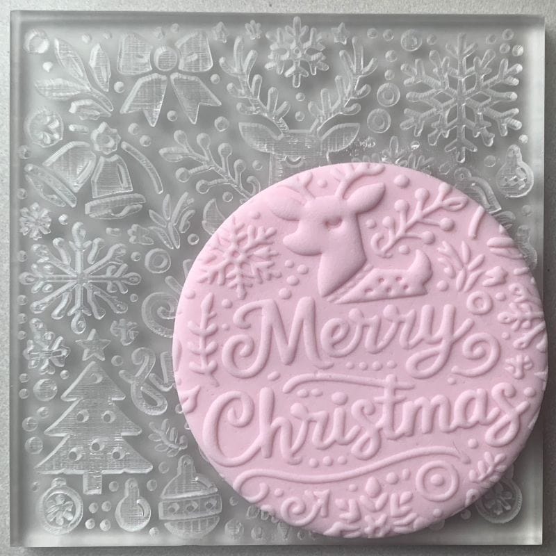 Magical Merry Christmas Reindeer embosser stamp with festive details on a round fondant cookie