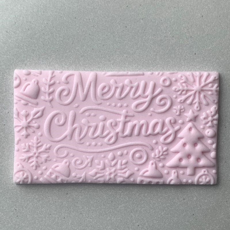 Rectangular fondant cookie with Merry Christmas typography and reindeer from a festive embosser stamp