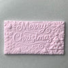 Rectangular fondant cookie with Merry Christmas typography and reindeer from a festive embosser stamp
