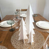 minimalist acrylic christmas tree decor arranged as festive table centerpiece
