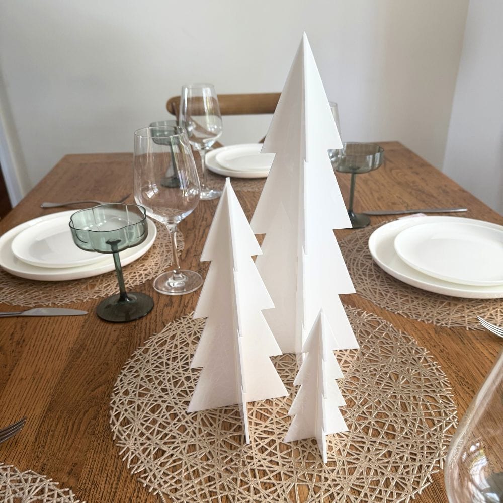 minimalist white acrylic christmas tree decor arranged as festive table centerpiece