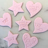 Set of heart and star fondant cookies using birthday stamps and cutters.