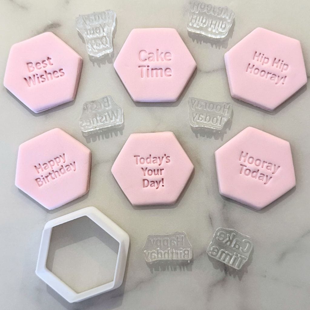 Set of six pink fondant cookies with birthday message stamps and matching hexagon cutter