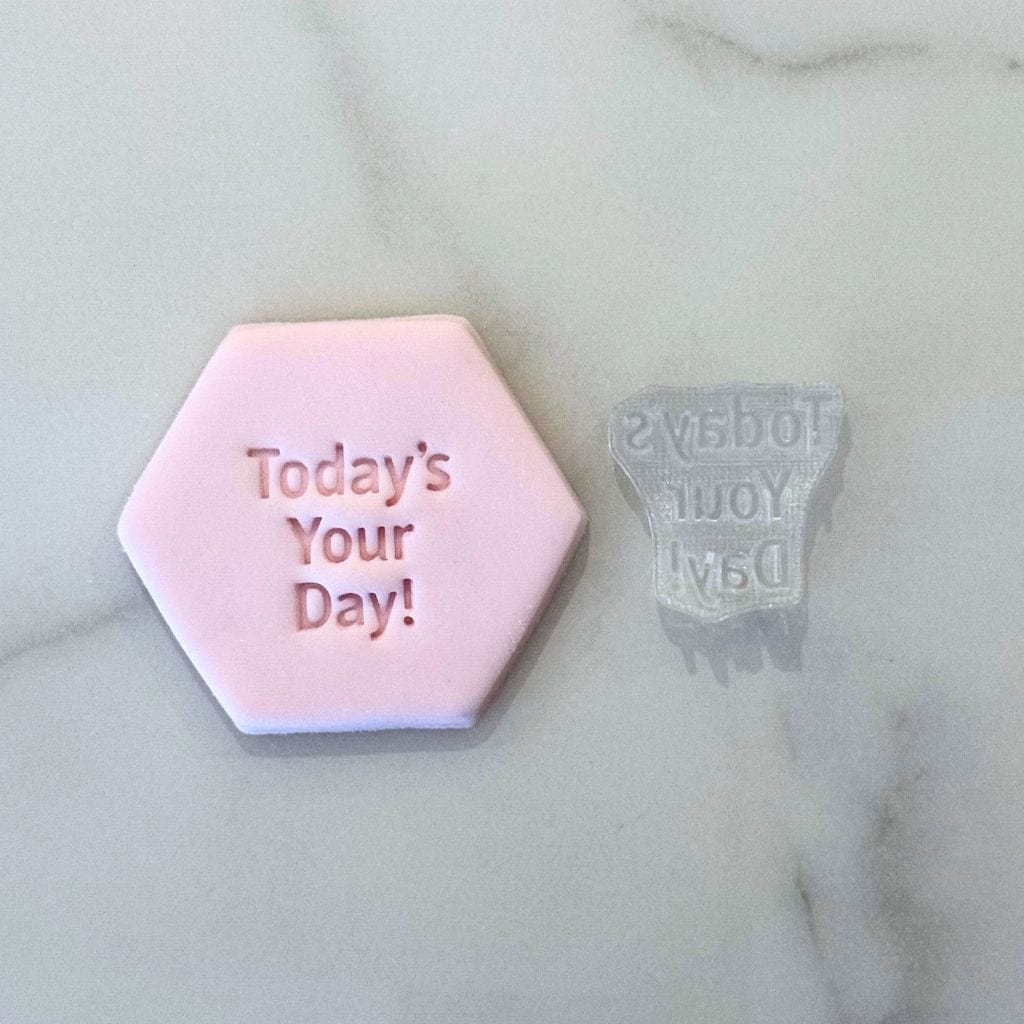 Today’s Your Day cookie stamp pressed into pink fondant with acrylic stamp shown