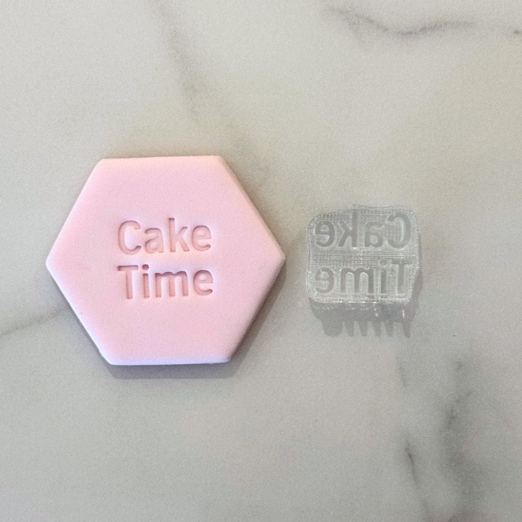 Happy Birthday cookie stamp impression on pink fondant with matching stamp.