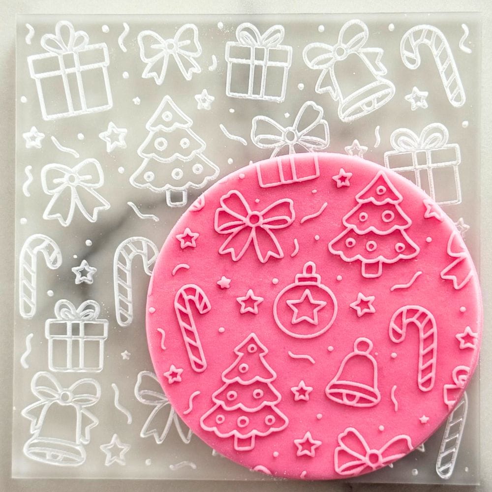 christmas cheer cookie stamp embosser on pink fondant cookie