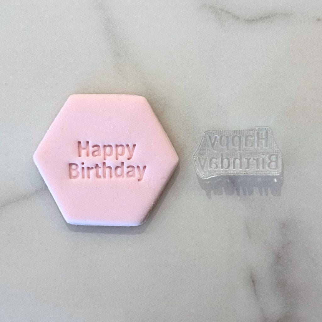 Pink fondant cookie with Cake Time text and matching clear stamp beside it