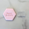 Pink fondant cookie with Cake Time text and matching clear stamp beside it