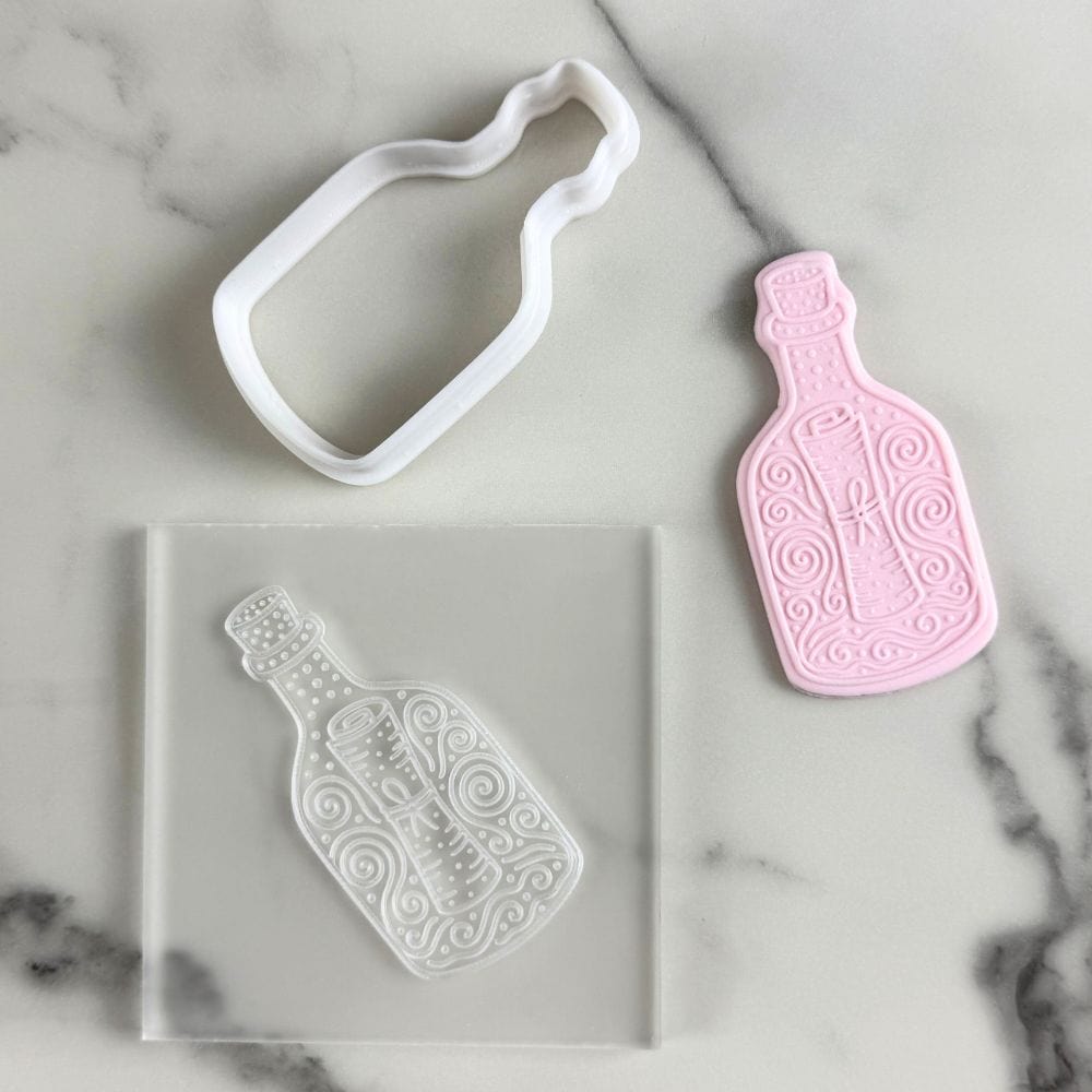 cookie cutter and embosser set featuring bottle and scroll design