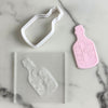cookie cutter and embosser set featuring bottle and scroll design