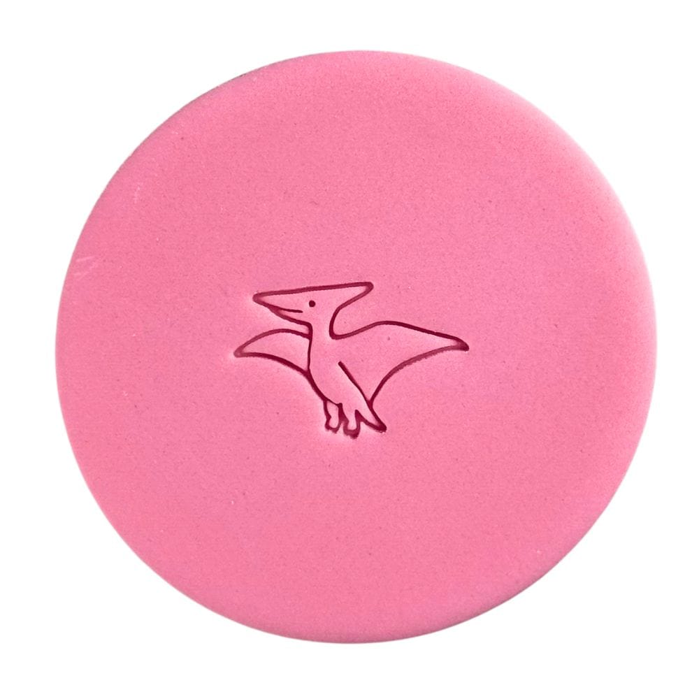 Mini pterodactyl fondant embossed cookie on pink background