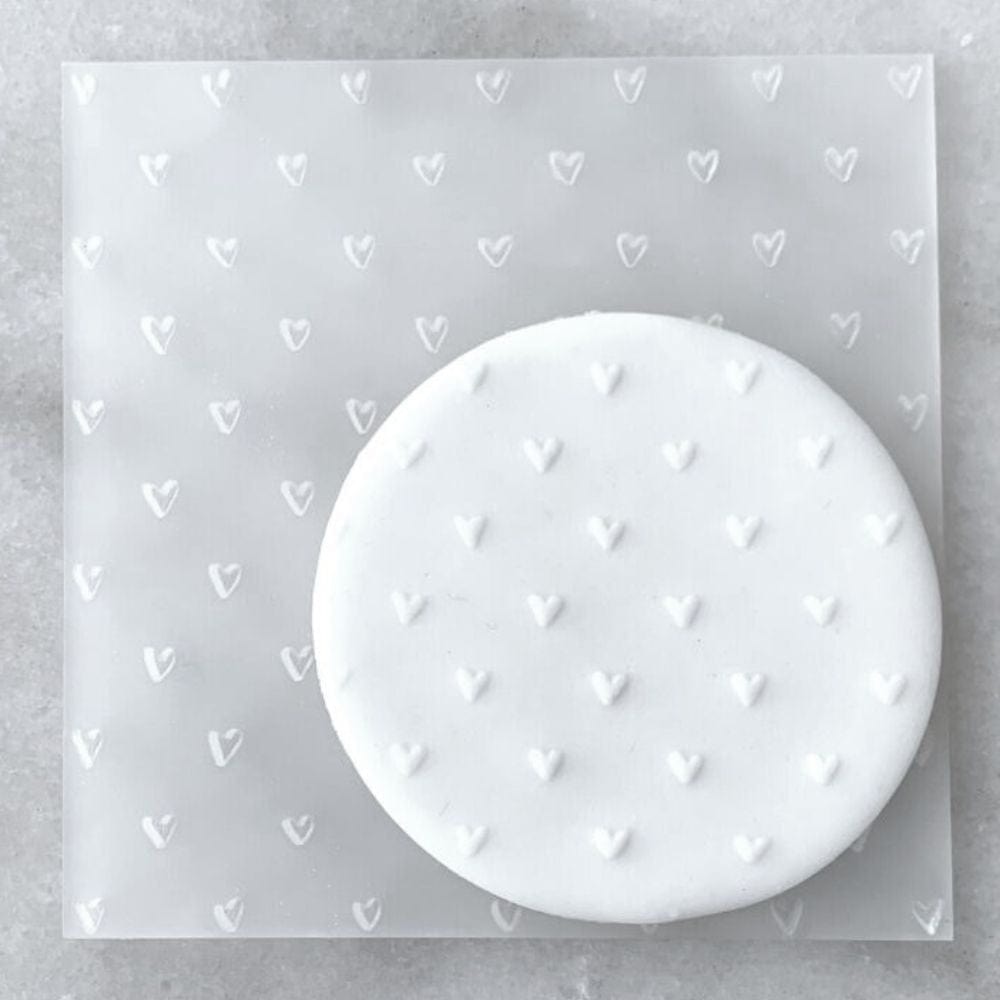 Cookie with Mini Hearts pattern created using an acrylic fondant debosser