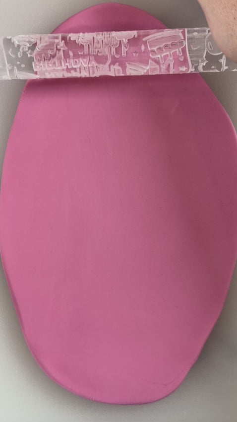 happy birthday classic textured rolling pin being used on cookie fondant