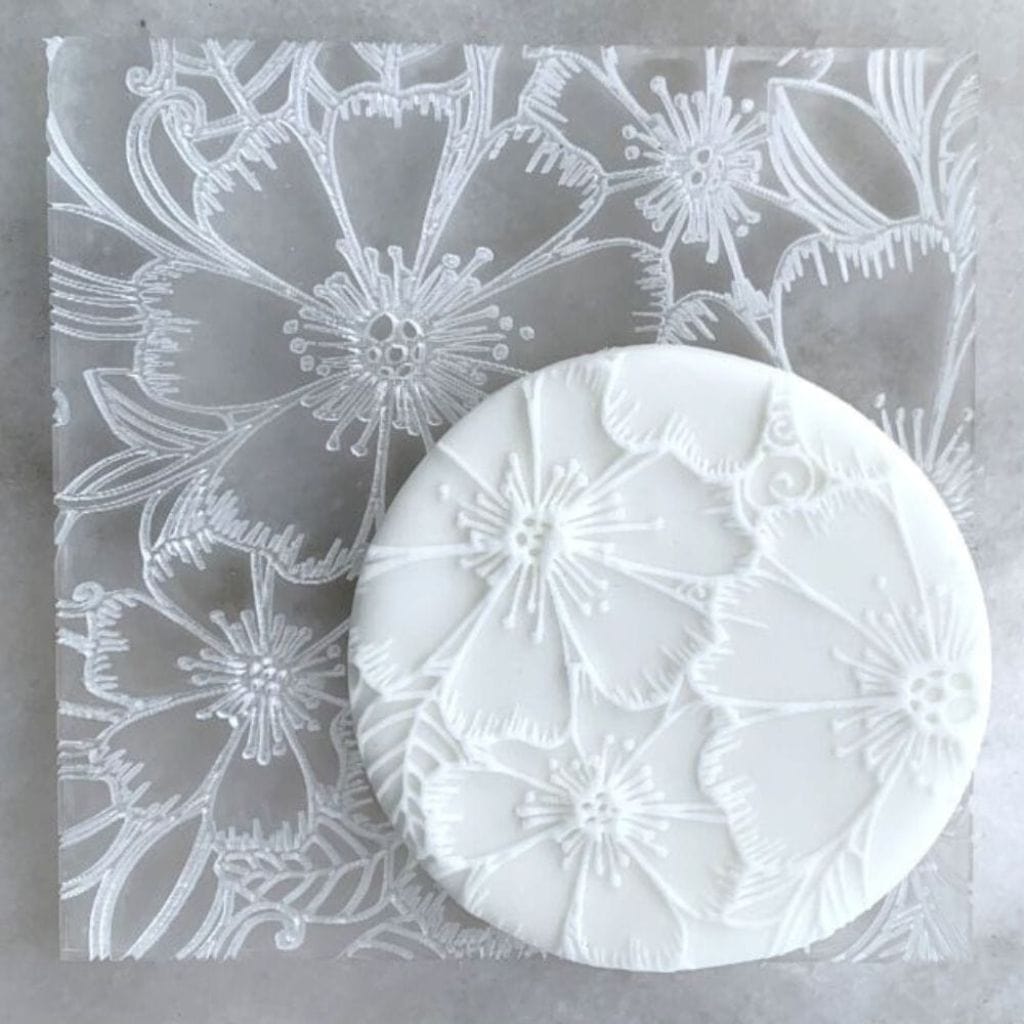 Cookie with Tropical Petals pattern created using an acrylic fondant debosser