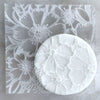 Cookie with Tropical Petals pattern created using an acrylic fondant debosser
