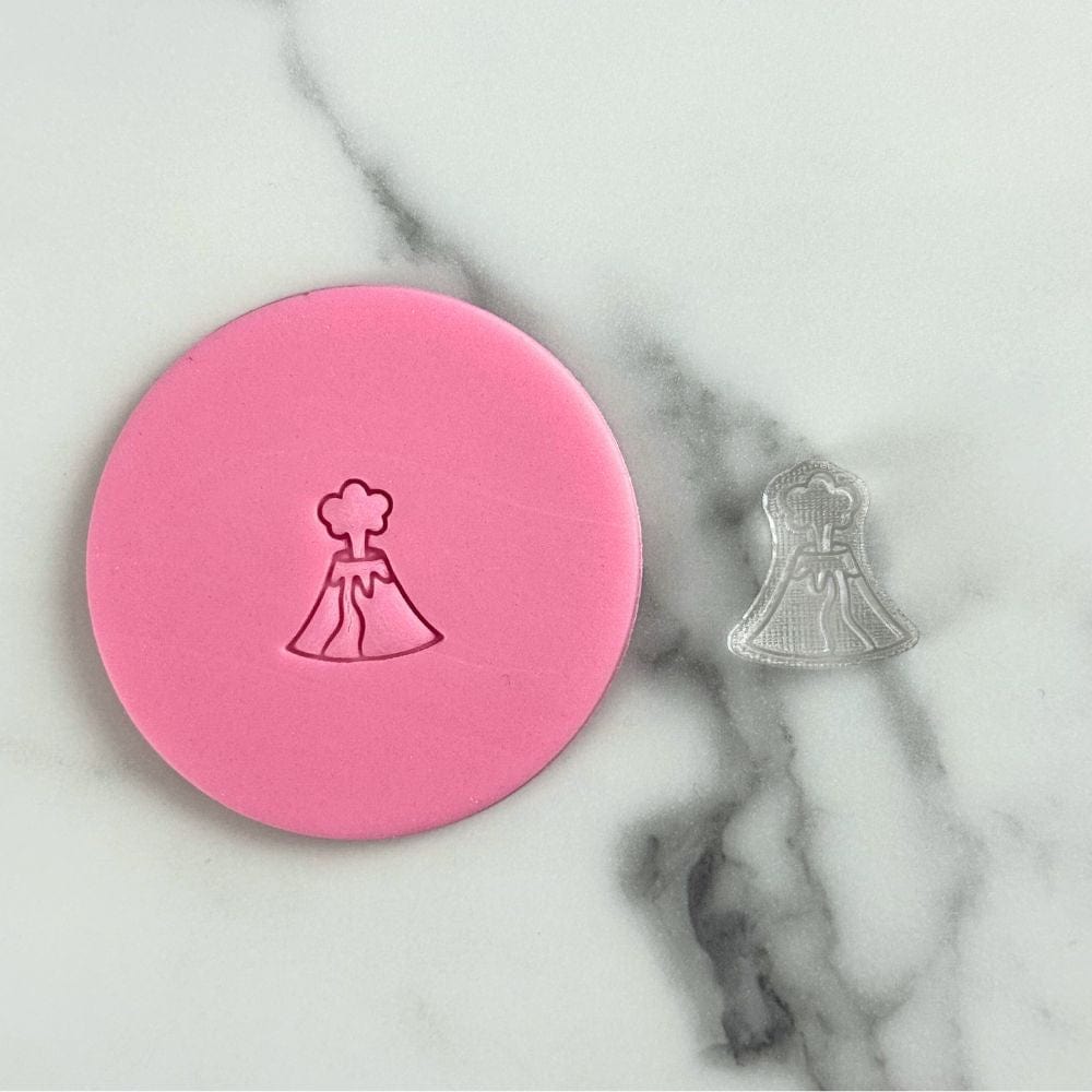 mini volcano cookie stamp shown next to stamped fondant design