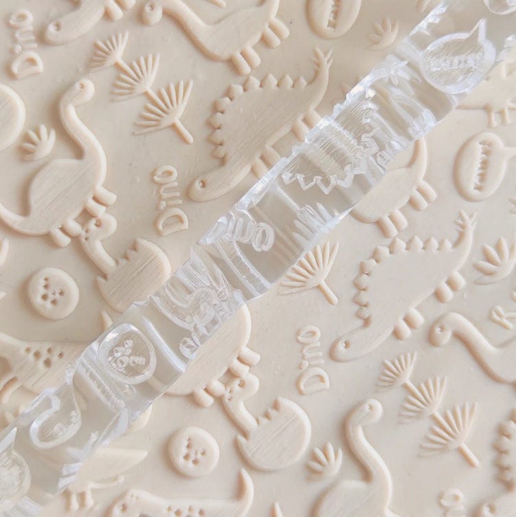 Close-up of Acrylic Embossed Rolling Pin with Baby Dinosaur Design | Ideal for Fondant Details