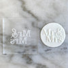 Custom acrylic embosser stamp beside a cookie decorated with 